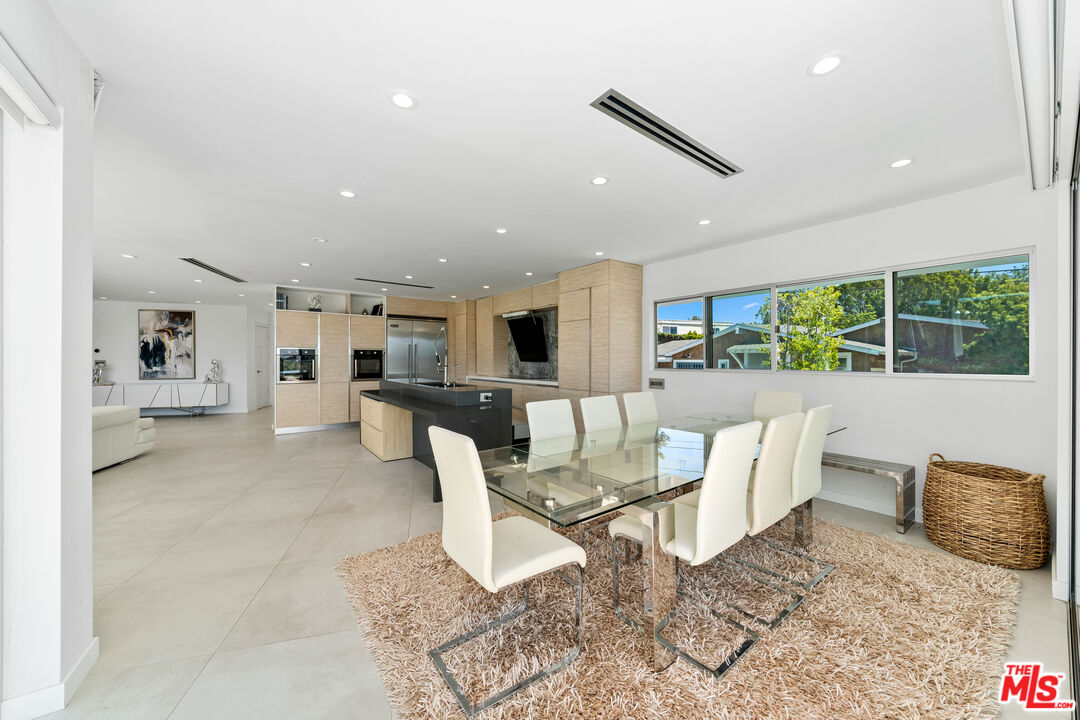 849 Glenmere Way Los Angeles, CA 90049 - Photo 21 of 51 a living room with furniture a rug kitchen view and a large window