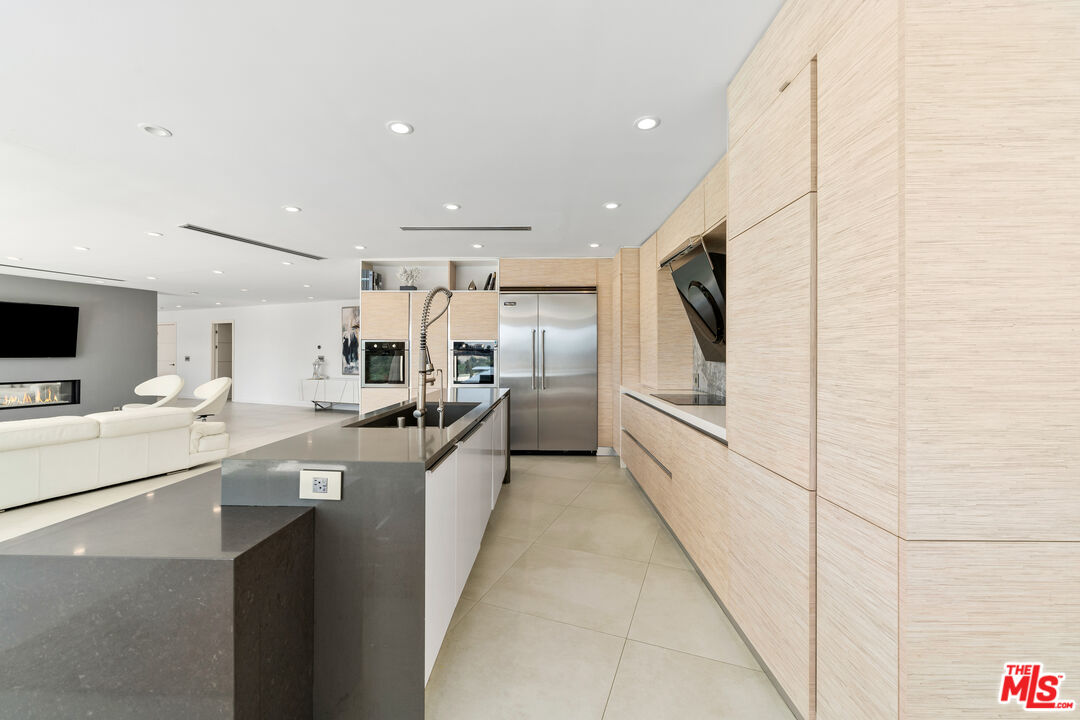 849 Glenmere Way Los Angeles, CA 90049 - Photo 23 of 51 a kitchen with stainless steel appliances kitchen island granite countertop a sink and cabinets