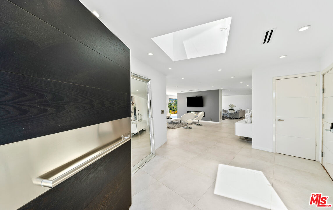 849 Glenmere Way Los Angeles, CA 90049 - Photo 4 of 51 a living room with furniture and a flat screen tv