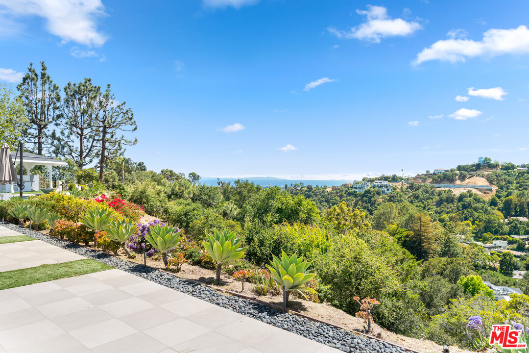 849 Glenmere Way Los Angeles, CA 90049 - Photo 44 of 51 a view of a garden with a building in background