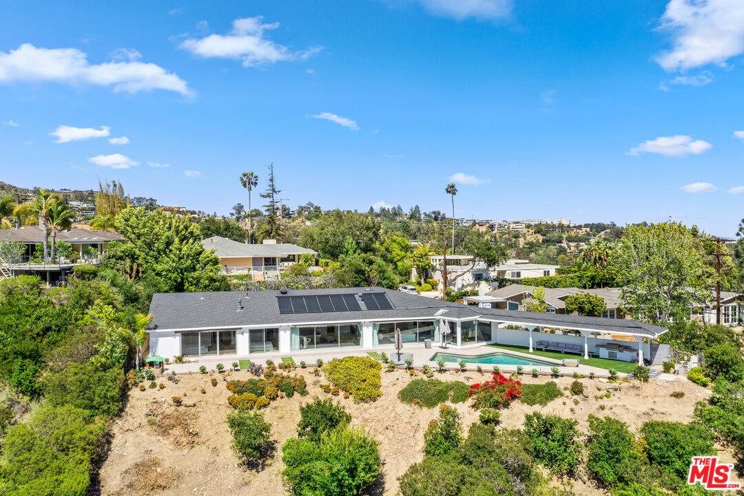849 Glenmere Way Los Angeles, CA 90049 - Photo 48 of 51 a view of a house with a big yard and large trees