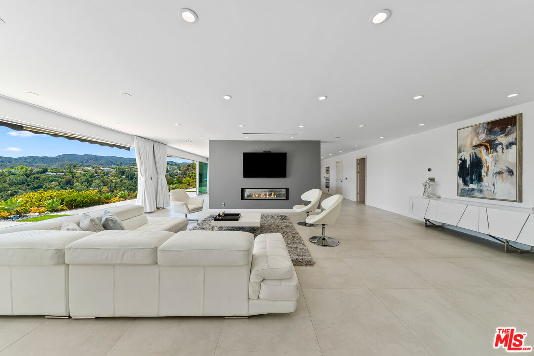 849 Glenmere Way Los Angeles, CA 90049 - Photo 8 of 51 a living room with furniture and a flat screen tv
