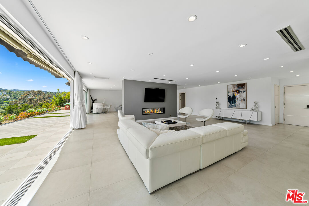 849 Glenmere Way Los Angeles, CA 90049 - Photo 9 of 51 a living room with furniture and a flat screen tv