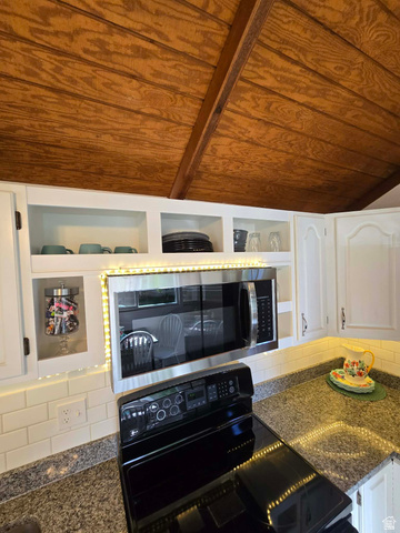 259 14th Street Ogden, UT 84404 - Photo 12 of 21 Kitchen featuring a wood-panel vaulted ceiling, white cabinetry, granite countertops, and a white subway tile backsplash
