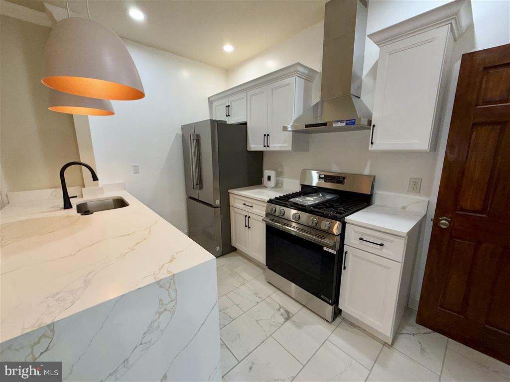 1154 4th Street Northeast Washington, DC 20002 - Photo 11 of 24 a kitchen with stainless steel appliances a refrigerator sink and stove