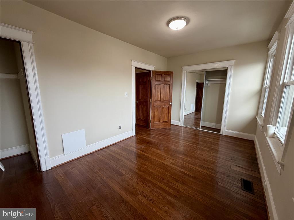 1154 4th Street Northeast Washington, DC 20002 - Photo 13 of 24 an empty room with wooden floor and closet