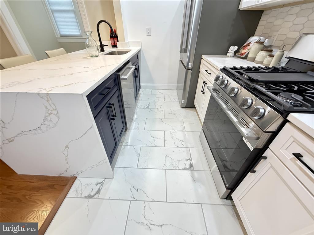 1154 4th Street Northeast Washington, DC 20002 - Photo 7 of 24 a kitchen with a stove and a sink