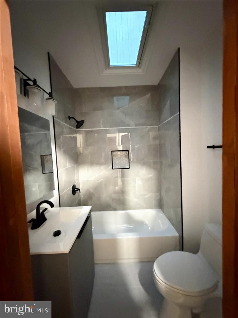 1154 4th Street Northeast Washington, DC 20002 - Photo 10 of 24 a bathroom with a sink mirror toilet and shower