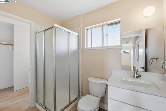 a bathroom with a toilet a sink and mirror