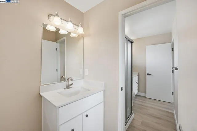 a bathroom with a sink a light fixture and a mirror