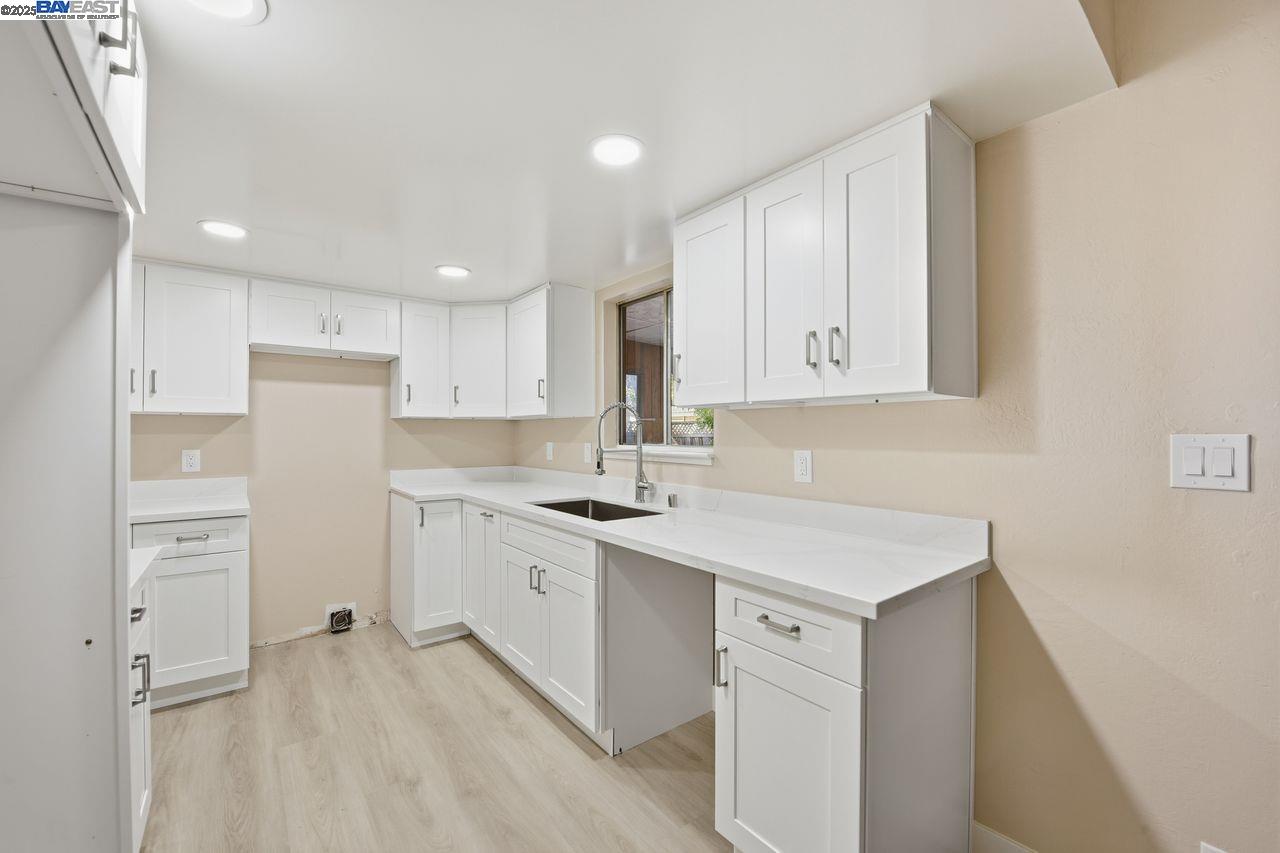 14544 Tiburon Road San Leandro, CA 94577 - Photo 8 of 26 a kitchen with white cabinets and white appliances