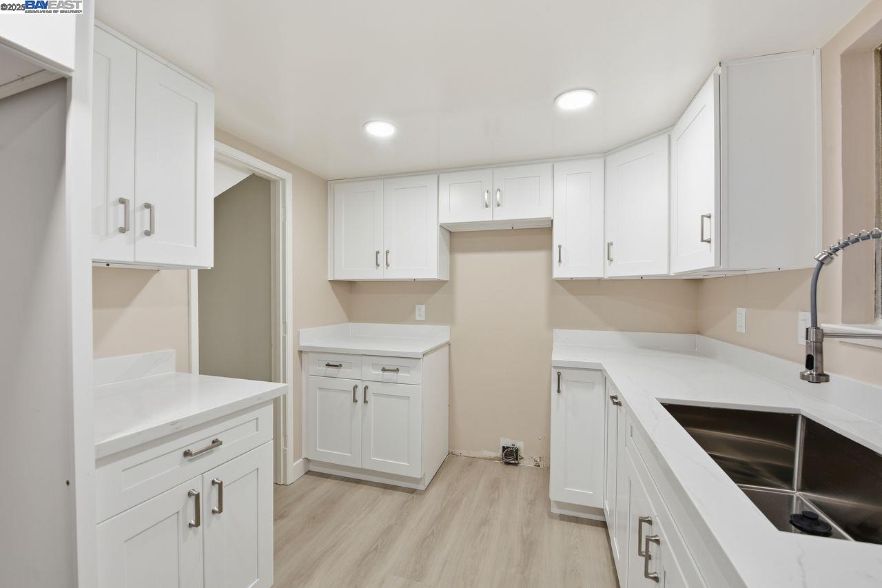 14544 Tiburon Road San Leandro, CA 94577 - Photo 9 of 26 a kitchen with white cabinets and white appliances