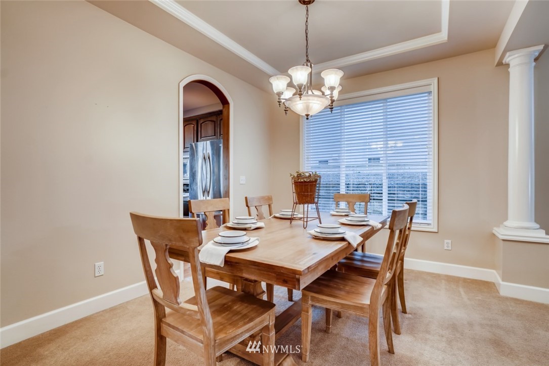 4121 223rd Place Southeast Bothell, WA 98021 - Photo 4 of 15 a view of a dining room with furniture wooden floor and chandelier