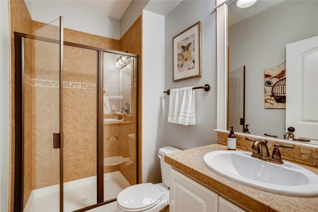 4121 223rd Place Southeast Bothell, WA 98021 - Photo 8 of 15 a bathroom with a sink toilet and shower