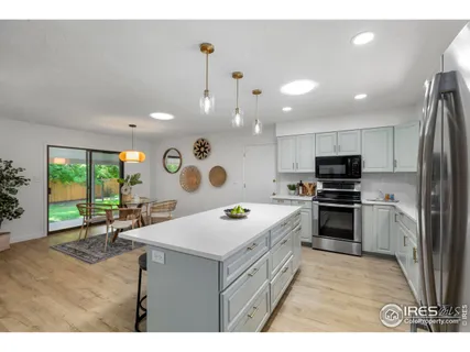 a kitchen with stainless steel appliances white cabinets a sink and a stove