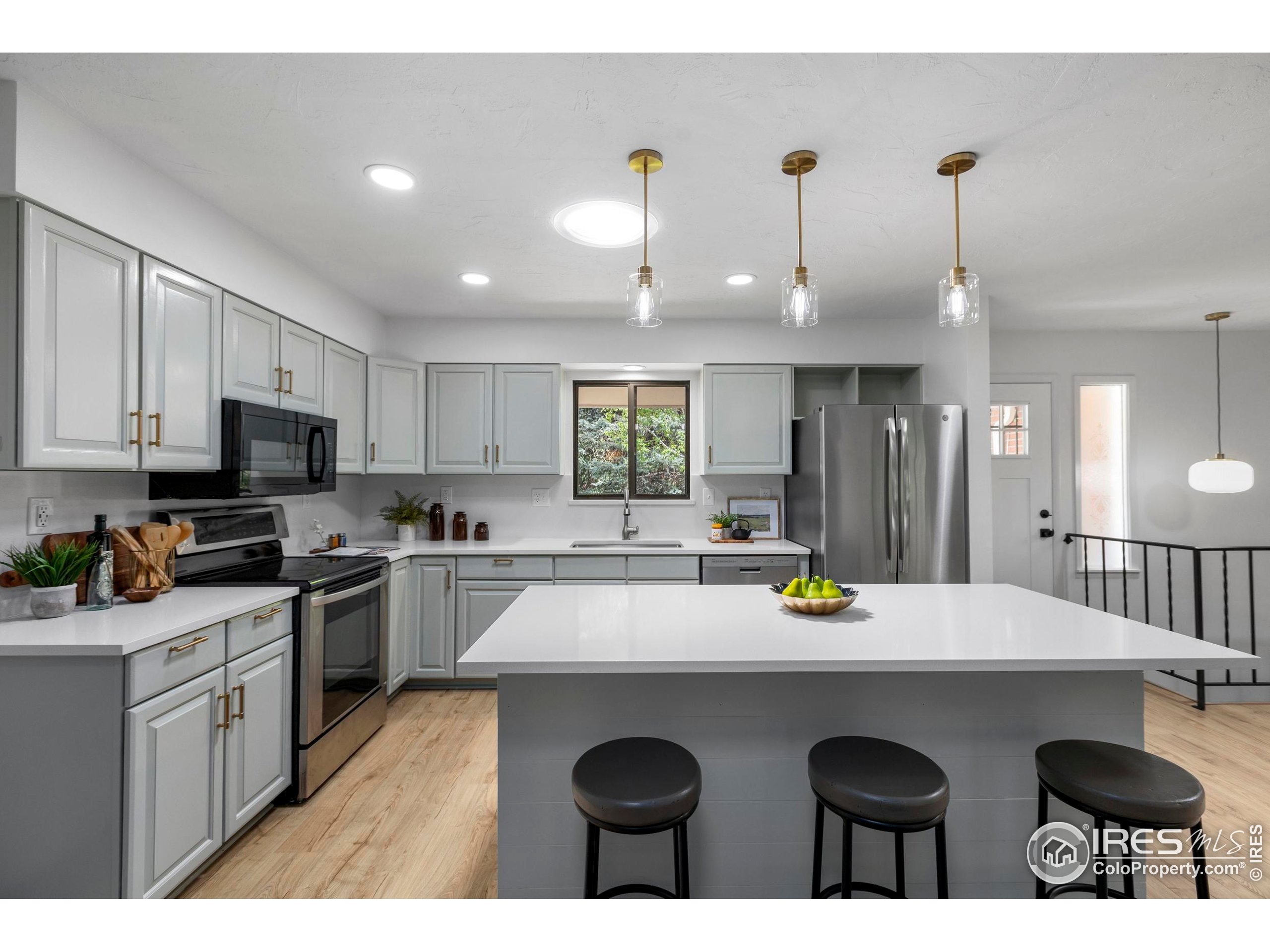 1917 South Lemay Avenue Fort Collins, CO 80525 - Photo 13 of 50 a kitchen with a sink a stove a refrigerator a dining table and chairs