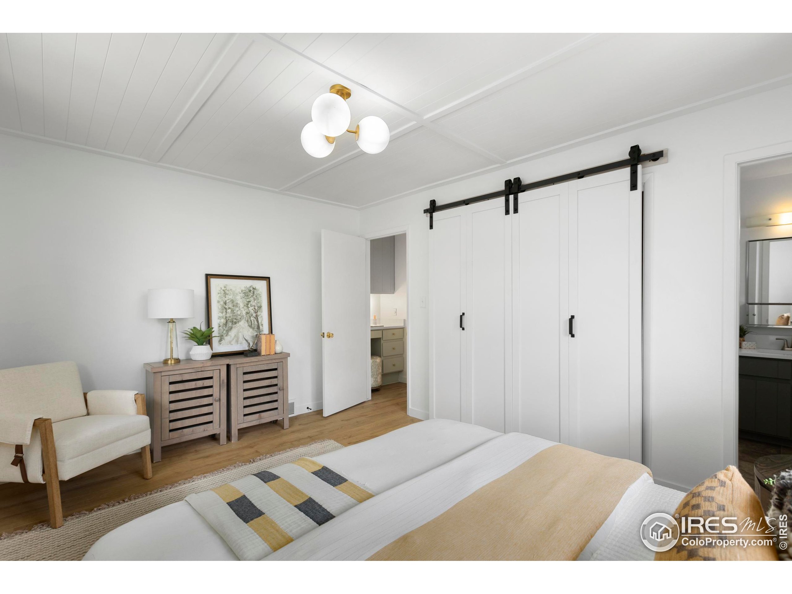 1917 South Lemay Avenue Fort Collins, CO 80525 - Photo 23 of 50 a bedroom with a bed and a chandelier