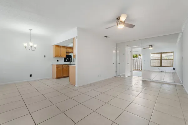 a view of a kitchen with furniture and an empty room
