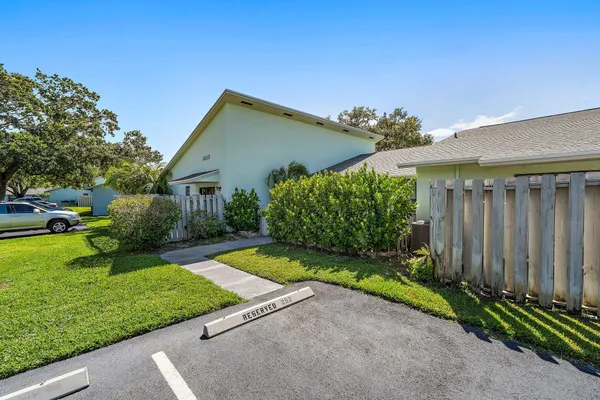 a view of a house with a yard and pathway