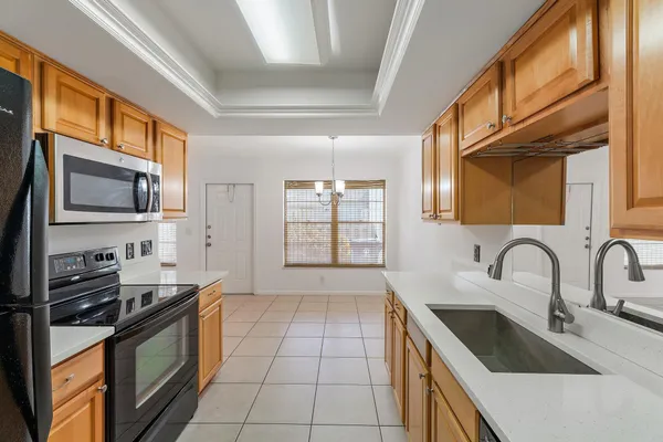 a kitchen with stainless steel appliances granite countertop a sink and a stove