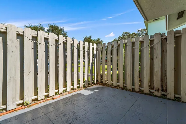 a view of a building with wooden fence