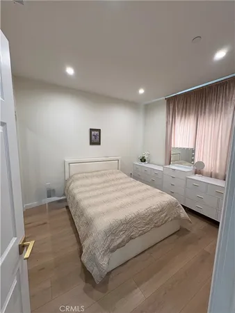 a spacious bedroom with a bed and a large window