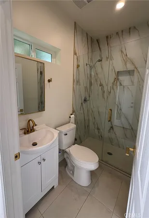 a bathroom with a toilet sink and shower