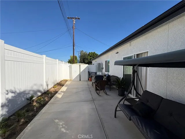a view of a patio with table and chairs potted plants with wooden floor