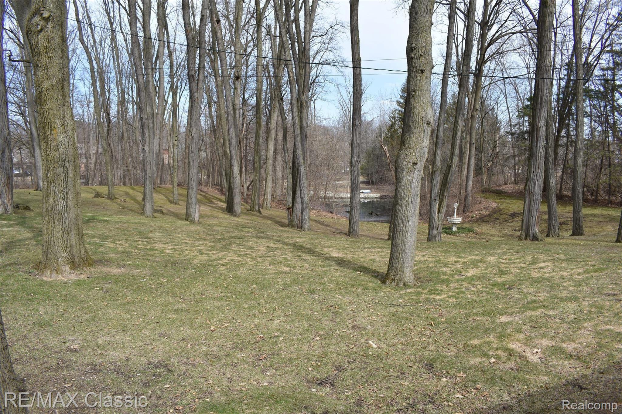 3980 Benstein Road Commerce Township, MI 48382 - Photo 26 of 68 Backyard and canal to Commerce Lake