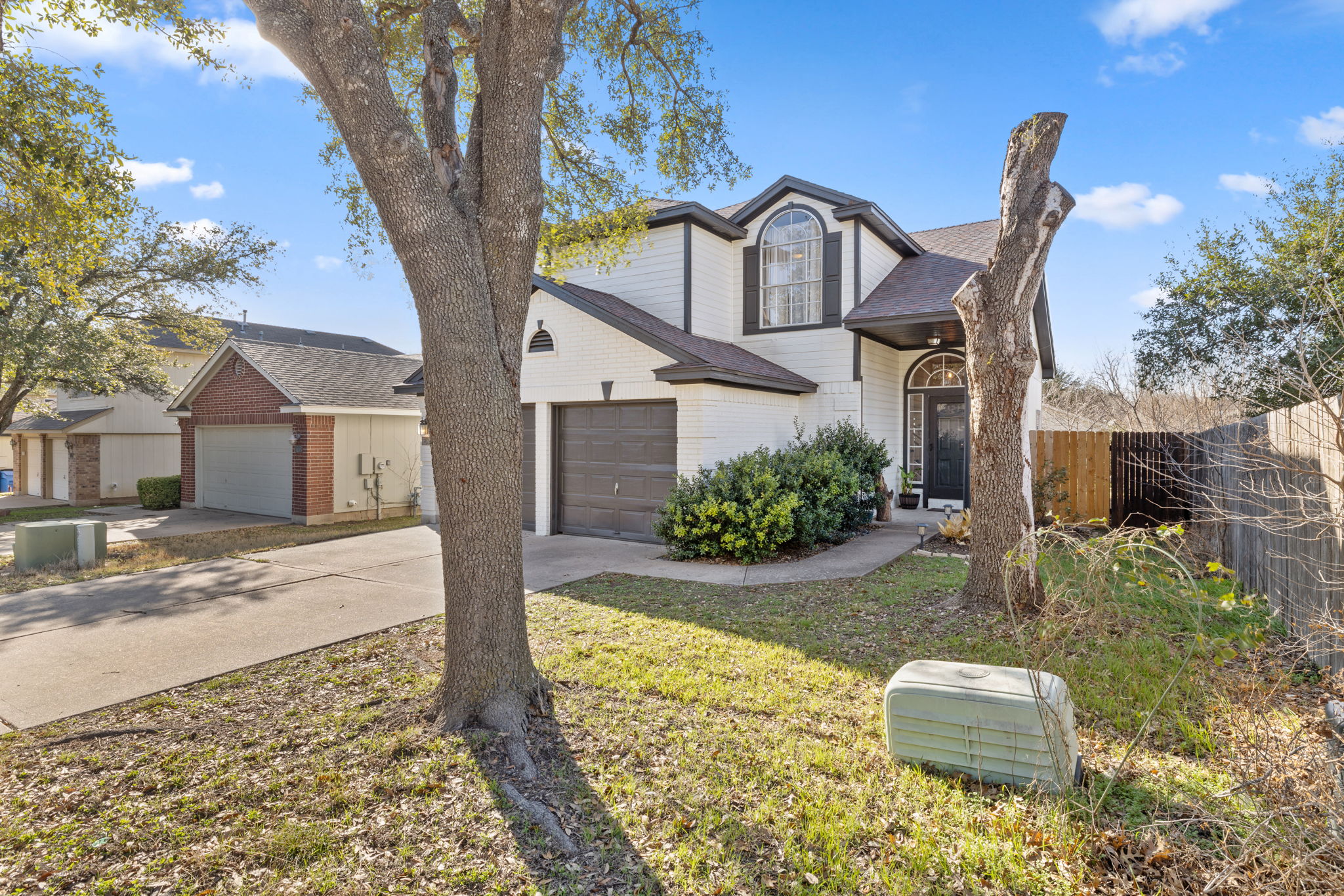 17536 Bishopsgate Drive Pflugerville, TX 78660 - Photo 2 of 28 Traditional-style house with a garage, driveway, a shingled roof, and brick siding