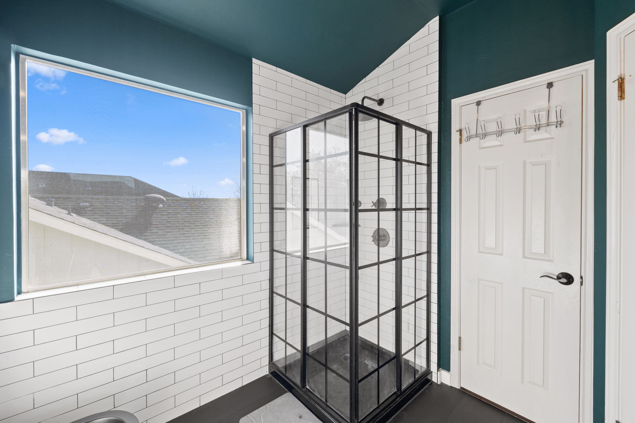 17536 Bishopsgate Drive Pflugerville, TX 78660 - Photo 22 of 35 Full bath with walk in shower, tile walls, and lofted ceiling