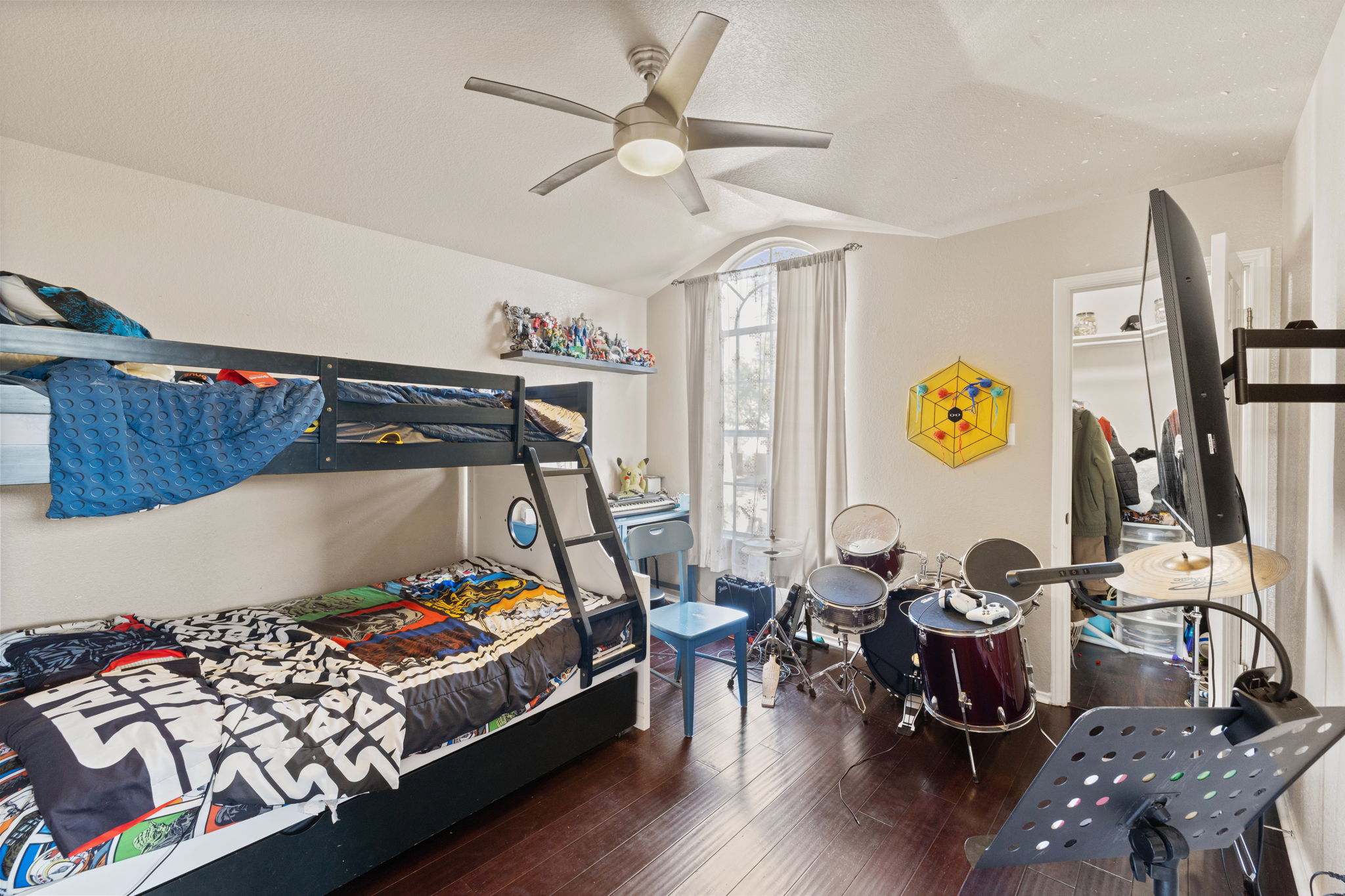 17536 Bishopsgate Drive Pflugerville, TX 78660 - Photo 22 of 28 Bedroom with dark wood finished floors, vaulted ceiling, a ceiling fan, and a closet