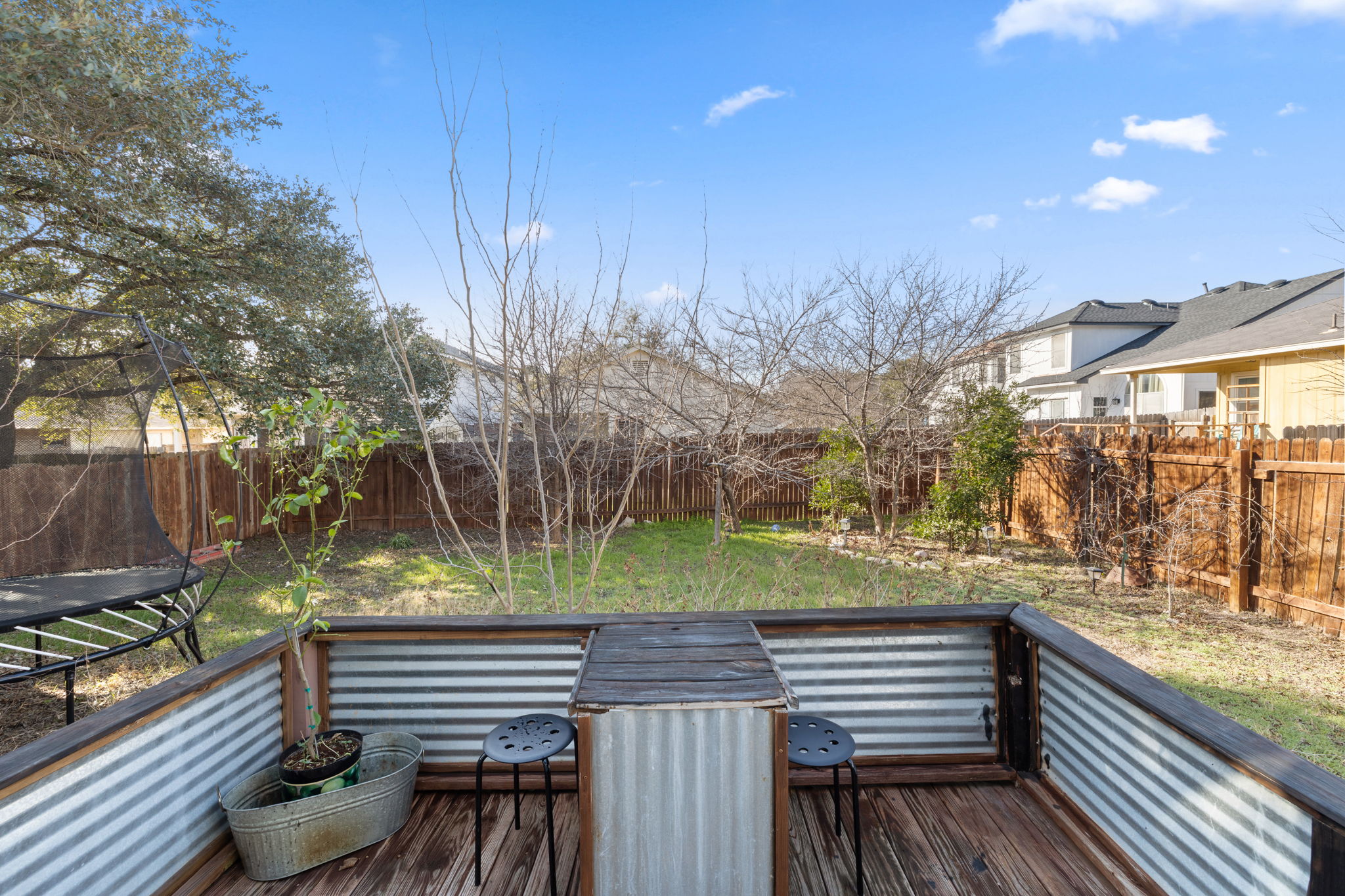 17536 Bishopsgate Drive Pflugerville, TX 78660 - Photo 28 of 28 Wooden deck with a trampoline and a fenced backyard