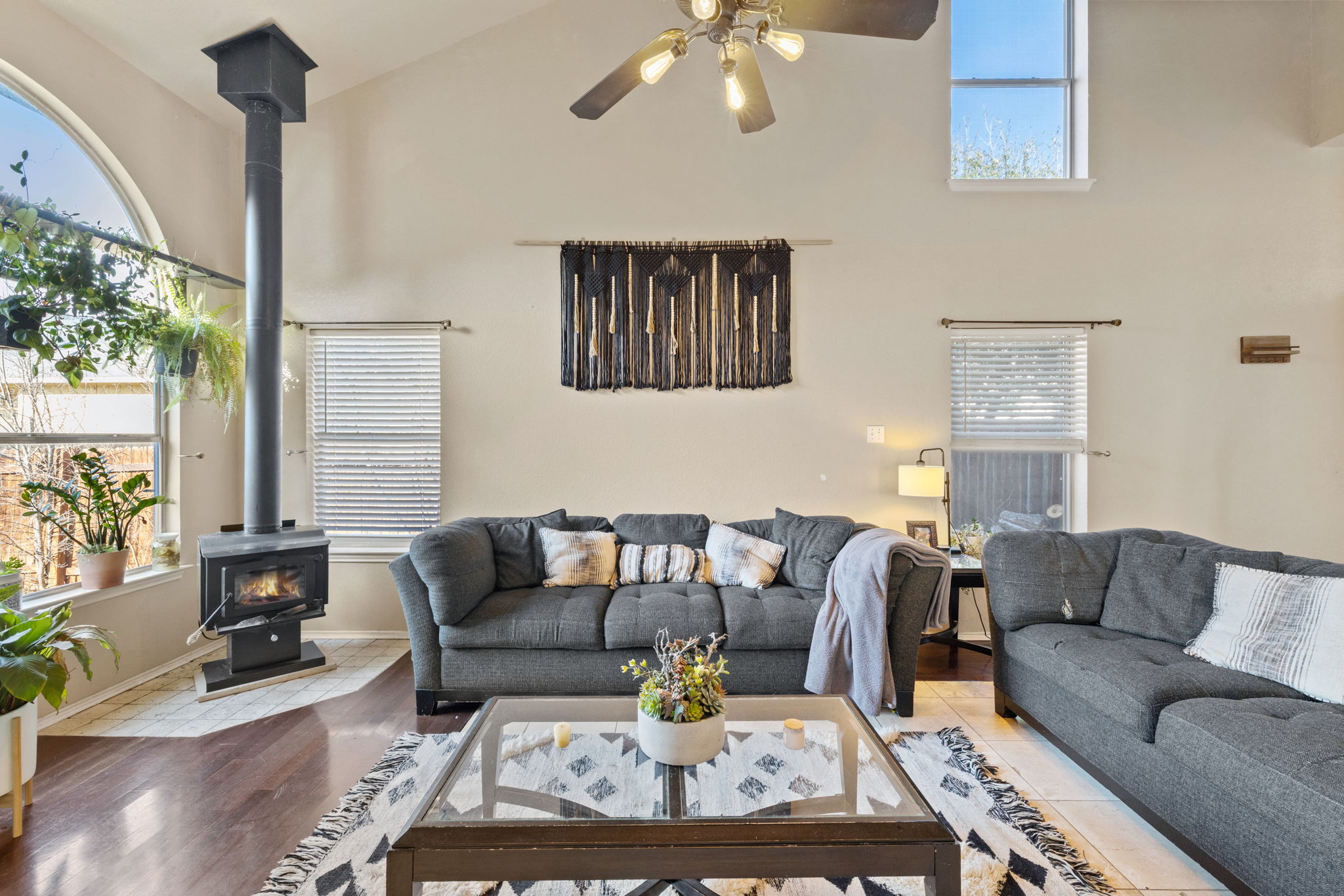 17536 Bishopsgate Drive Pflugerville, TX 78660 - Photo 7 of 28 Living area featuring a wood stove and a ceiling fan