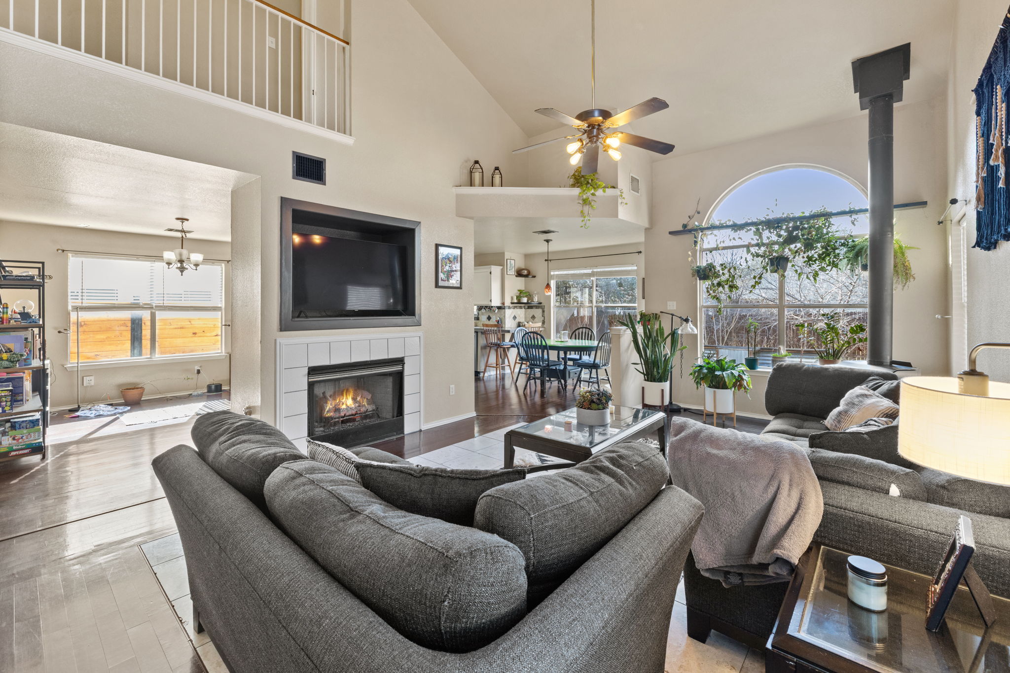 17536 Bishopsgate Drive Pflugerville, TX 78660 - Photo 8 of 28 Living area with lofted ceiling, hardwood / wood-style floors, ceiling fan, and plenty of natural light