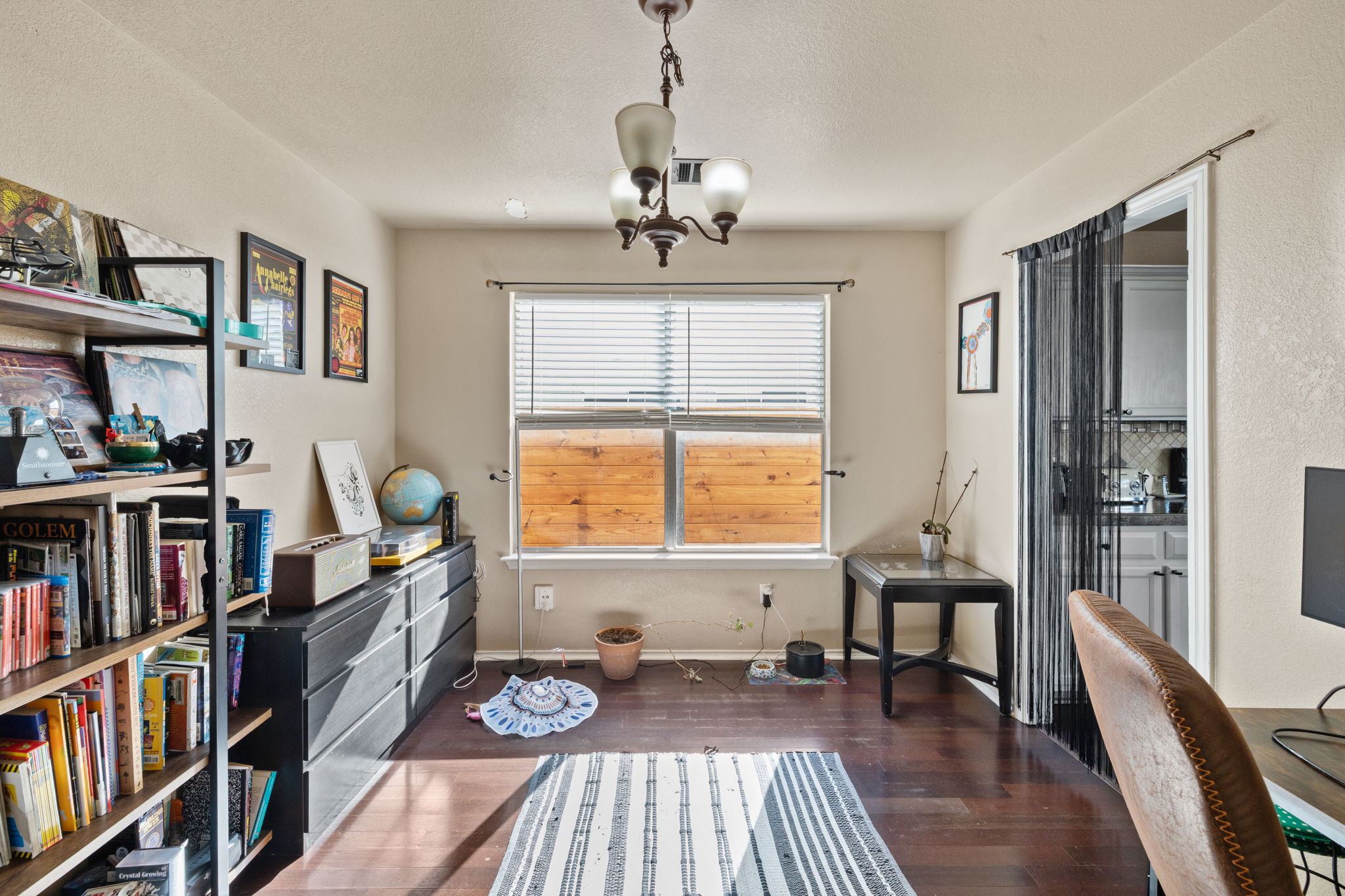 17536 Bishopsgate Drive Pflugerville, TX 78660 - Photo 9 of 28 Living area featuring dark wood-style floors and a chandelier