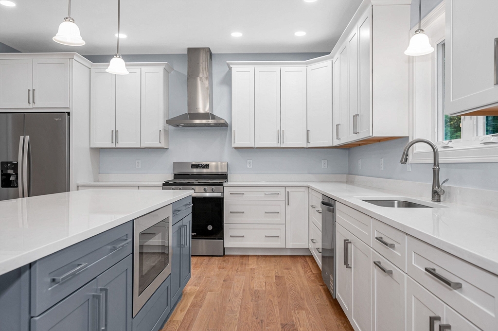 15 Norris Road Tyngsborough, MA 01879 - Photo 12 of 42 a kitchen with a sink stove and cabinets