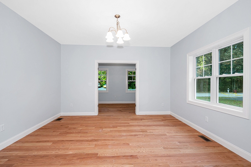 15 Norris Road Tyngsborough, MA 01879 - Photo 14 of 42 a view of an empty room with wooden floor and a window