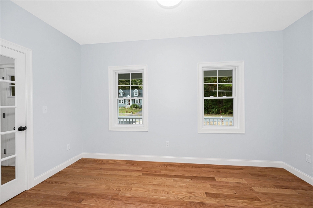 15 Norris Road Tyngsborough, MA 01879 - Photo 16 of 42 an empty room with wooden floor and windows