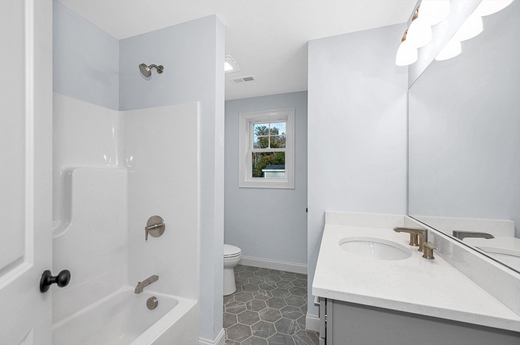 15 Norris Road Tyngsborough, MA 01879 - Photo 20 of 42 a bathroom with a sink a toilet and shower