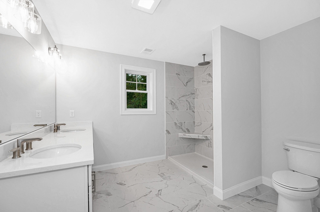 15 Norris Road Tyngsborough, MA 01879 - Photo 30 of 42 a bathroom with a granite countertop sink toilet and shower