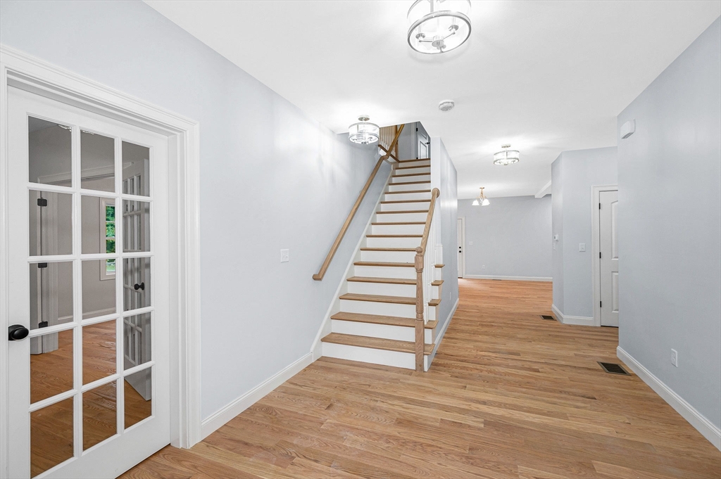 15 Norris Road Tyngsborough, MA 01879 - Photo 3 of 42 a view of entryway with stairs and wooden floor
