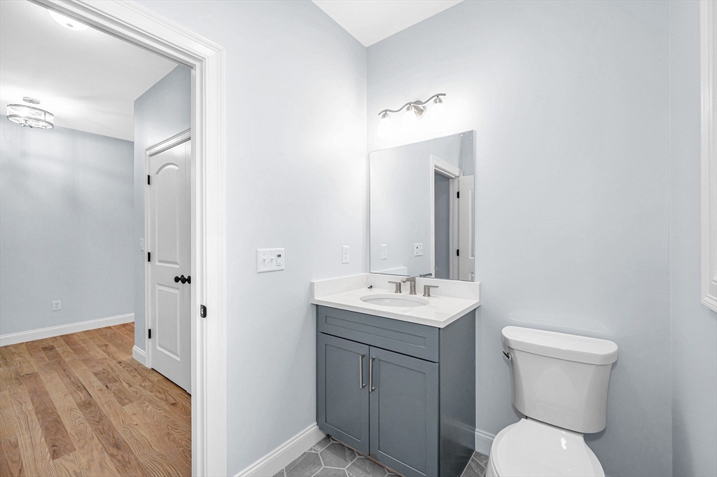 15 Norris Road Tyngsborough, MA 01879 - Photo 5 of 42 a bathroom with a toilet sink and mirror