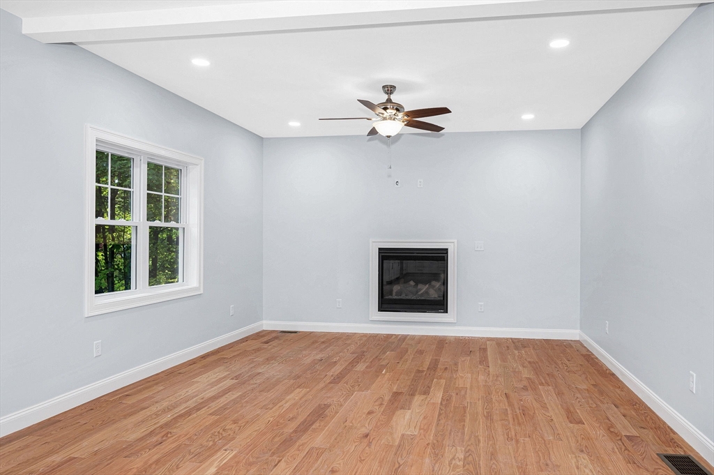 15 Norris Road Tyngsborough, MA 01879 - Photo 6 of 42 a view of an empty room with a window and wooden floor