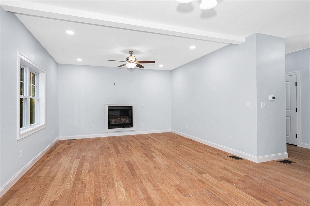 15 Norris Road Tyngsborough, MA 01879 - Photo 7 of 42 a view of an empty room with wooden floor and a window
