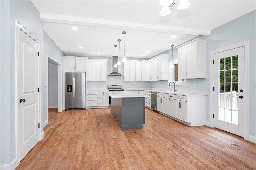 15 Norris Road Tyngsborough, MA 01879 - Photo 9 of 42 a kitchen with stainless steel appliances a refrigerator sink and cabinets