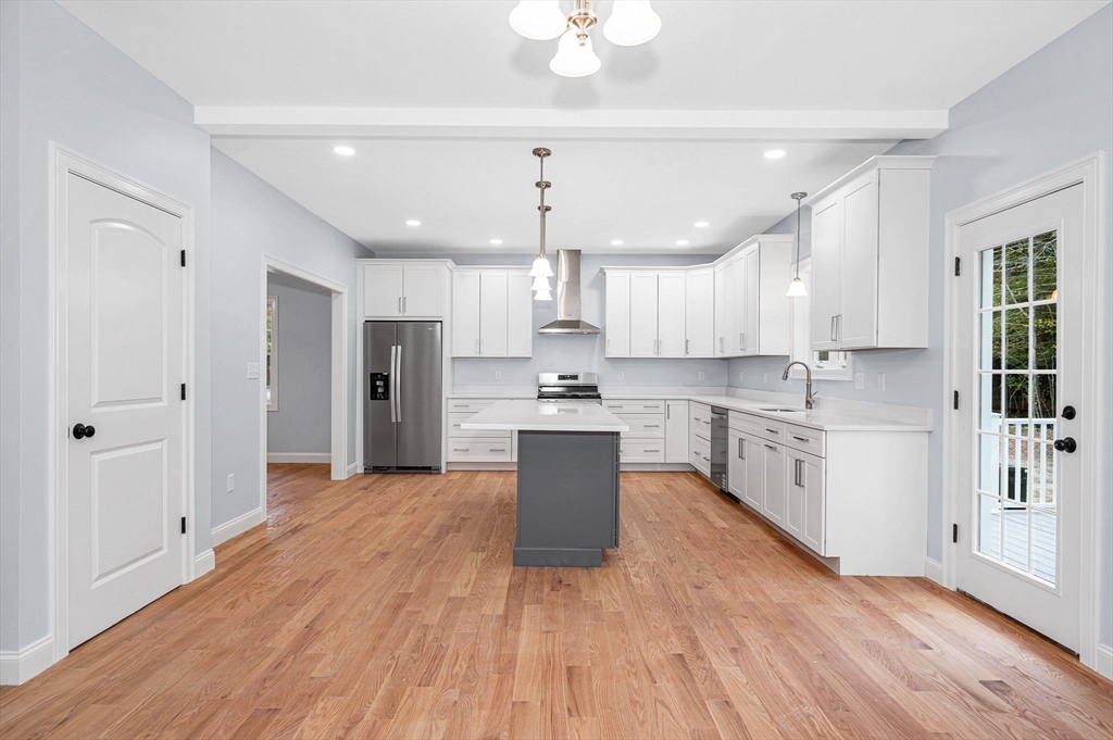 15 Norris Road Tyngsborough, MA 01879 - Photo 10 of 42 a large kitchen with cabinets wooden floor and a window