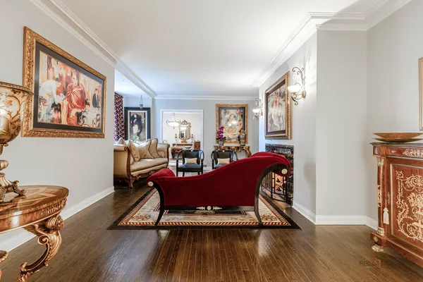 a living room with furniture a rug and a chandelier