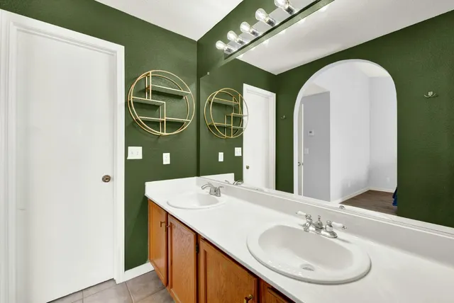 an aerial view of a house with outdoor space and trees all around