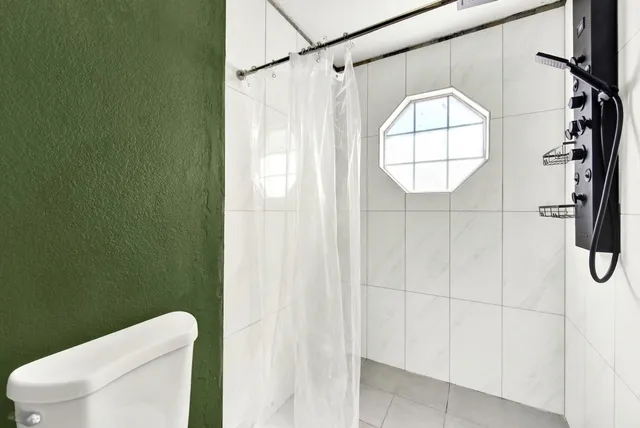 a view of a patio with table and chairs potted plants and large tree
